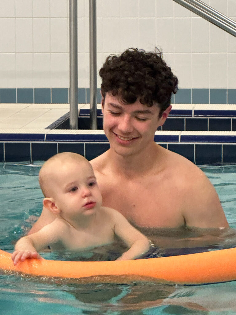 brothers in water babies lessson on pool noodle