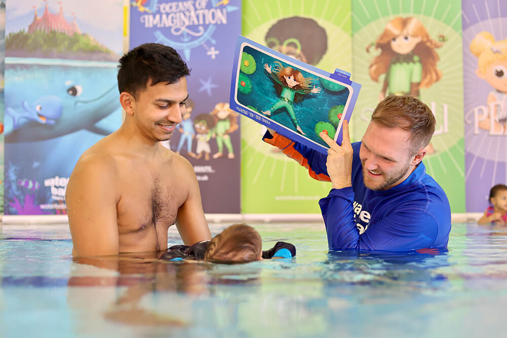water babies teacher with dad and baby swimming on back