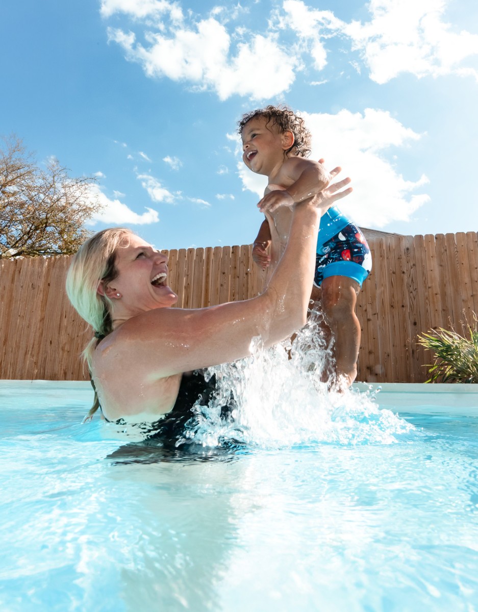 mum and baby splashing in the pool