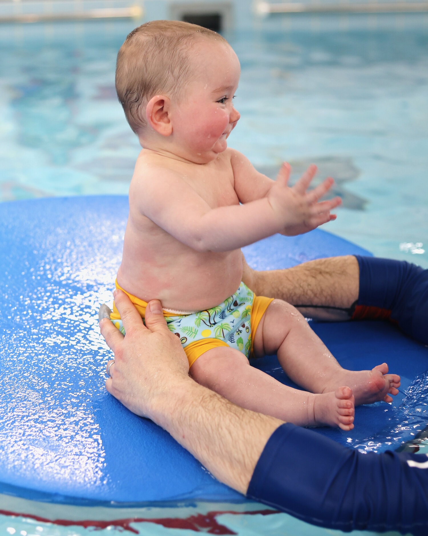 water babies baby on a round mat in swimming lessons